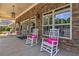 Inviting porch with stone accents, rocking chairs, and pink pillows, perfect for relaxing and enjoying the outdoors at 2017 Grove Field Ln, Marietta, GA 30064