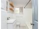 A bathroom with white tiled walls, a white vanity, a toilet, and a tub with shower at 2542 Warwick Ne Cir, Atlanta, GA 30345