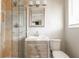 Well-lit bathroom with a glass enclosed shower with a tiled surround, a modern vanity, and a toilet at 2542 Warwick Ne Cir, Atlanta, GA 30345