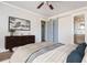 A bedroom featuring an abstract wall art piece above a dark wood credenza with sliding door to ensuite bathroom at 2542 Warwick Ne Cir, Atlanta, GA 30345