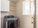 Laundry room featuring a front loading washer and dryer below upper cabinets at 2542 Warwick Ne Cir, Atlanta, GA 30345