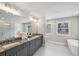 Elegant bathroom with dual vanities, a large mirror, a soaking tub and separate glass shower at 3119 Stonegate Sw Dr, Atlanta, GA 30331