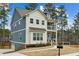 Charming two-story home featuring a blue and white color scheme, porch, and well-manicured lawn at 3119 Stonegate Sw Dr, Atlanta, GA 30331