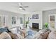 Bright living room with a fireplace, fan, hardwood floors, and ample natural light at 3119 Stonegate Sw Dr, Atlanta, GA 30331