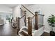 Elegant staircase with dark wood banister and railing, complemented by natural lighting at 3119 Stonegate Sw Dr, Atlanta, GA 30331