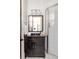 Well-lit bathroom featuring a dark wood vanity and a glass-enclosed shower with white tile at 9121 Selborne Ln, Chattahoochee Hills, GA 30268
