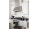 Modern kitchen features stainless steel appliances, white cabinets and black countertops at 9121 Selborne Ln, Chattahoochee Hills, GA 30268