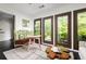 Cozy living room bathed in natural light, highlighting seamless indoor-outdoor connection at 9121 Selborne Ln, Chattahoochee Hills, GA 30268