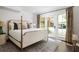 Bright bedroom featuring doors to yard and stylish curtains enhancing the natural light at 9121 Selborne Ln, Chattahoochee Hills, GA 30268