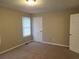 Bedroom displaying neutral carpeting, a window with blinds, door and classic ceiling light fixture at 2649 Fieldstone View Se Ln, Conyers, GA 30013