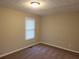 Bedroom showcasing neutral carpet, a window, and classic ceiling light fixture, simple yet comfortable at 2649 Fieldstone View Se Ln, Conyers, GA 30013