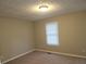 Cozy bedroom featuring neutral carpeting, a window with blinds, and a classic ceiling light fixture at 2649 Fieldstone View Se Ln, Conyers, GA 30013