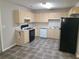 Traditional kitchen featuring tile floor, light wood cabinets, and modern appliances at 2649 Fieldstone View Se Ln, Conyers, GA 30013