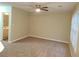 Neutral living room with ceiling fan, carpet, and view to bathroom with vanity at 2649 Fieldstone View Se Ln, Conyers, GA 30013