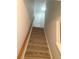 Carpeted staircase leading up to the second floor with a wood handrail at 2649 Fieldstone View Se Ln, Conyers, GA 30013