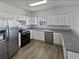 Modern kitchen featuring white cabinetry, stainless steel appliances, and durable countertops at 3180 Oakley Pl, Union City, GA 30291