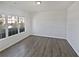 Bright living room featuring a neutral color palette, new flooring, and large window at 3180 Oakley Pl, Union City, GA 30291