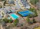 Aerial view of a community pool and tennis courts surrounded by lush trees at 4205 Rock Creek Dr, Cumming, GA 30028