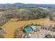 Aerial view of a community featuring a lake, swimming pool, and tennis courts at 4205 Rock Creek Dr, Cumming, GA 30028