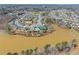 Expansive aerial view of a neighborhood with a community pool, tennis courts, and pond at 4205 Rock Creek Dr, Cumming, GA 30028