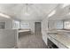 A luxury bathroom featuring double sinks, granite counters, wood look tile, decorative lighting and a large soaking tub at 4205 Rock Creek Dr, Cumming, GA 30028