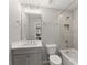 Bathroom featuring tub with shower and modern lighting at 4205 Rock Creek Dr, Cumming, GA 30028