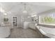 A spacious bathroom featuring double sinks, granite counters, wood look tile, soaking tub and glass enclosed shower at 4205 Rock Creek Dr, Cumming, GA 30028