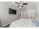 Airy bedroom with hardwood floors, a ceiling fan, and a large screen tv at 4205 Rock Creek Dr, Cumming, GA 30028