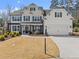 Beautiful two-story home boasts a manicured lawn and welcoming front porch with stone accents at 4205 Rock Creek Dr, Cumming, GA 30028