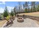 Inviting stone fire pit area with comfortable seating, ideal for relaxing evenings at 4205 Rock Creek Dr, Cumming, GA 30028