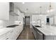 Well-equipped kitchen featuring stainless steel appliances, white cabinetry, a subway tile backsplash, and a large island at 4205 Rock Creek Dr, Cumming, GA 30028