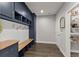 Mudroom with a built-in bench, storage cabinets, coat hooks, a wooden countertop, and a door to the pantry at 4205 Rock Creek Dr, Cumming, GA 30028