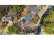 Aerial view of a traditional-style home with a circular driveway and mature trees at 4335 Halifax Ne Ter, Roswell, GA 30075