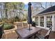 Spacious back deck with outdoor dining set, grill, and peaceful view of the surrounding trees at 4335 Halifax Ne Ter, Roswell, GA 30075