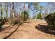 Wooded backyard featuring trees, short wood fence, and a grass-free backyard at 4335 Halifax Ne Ter, Roswell, GA 30075