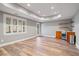 Finished basement area with wood-look flooring, a mini bar, a window, recessed lighting, and an exit door at 4335 Halifax Ne Ter, Roswell, GA 30075