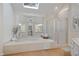 Bright bathroom featuring large tub, glass shower, skylight, and mirrored wall for an open feel at 4335 Halifax Ne Ter, Roswell, GA 30075