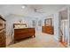 Spacious bedroom with carpet, light gray walls, a wooden bed set, and windows providing natural light at 4335 Halifax Ne Ter, Roswell, GA 30075