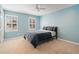 Bedroom with blue walls, carpet, and a window offering natural light, and a double bed with stylish bedding at 4335 Halifax Ne Ter, Roswell, GA 30075