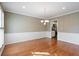 Elegant dining room with hardwood floors, chair railing, and a stylish chandelier at 4335 Halifax Ne Ter, Roswell, GA 30075