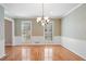 Bright dining room with hardwood floors, chair railing, and two shuttered windows at 4335 Halifax Ne Ter, Roswell, GA 30075