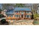 Traditional red brick home with a blue roof, green shutters and manicured landscaping at 4335 Halifax Ne Ter, Roswell, GA 30075