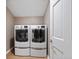 Modern laundry room featuring a set of large, front-load washer and dryer units at 4335 Halifax Ne Ter, Roswell, GA 30075