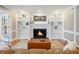 Bright living room featuring a fireplace, built-in shelves, and hardwood floors at 4335 Halifax Ne Ter, Roswell, GA 30075