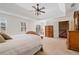 Bright main bedroom with tray ceilings, windows, plush carpet, and detailed wood furniture at 4335 Halifax Ne Ter, Roswell, GA 30075