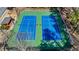 Aerial view of a pair of tennis courts with players mid-game and blue and green surface at 4335 Halifax Ne Ter, Roswell, GA 30075