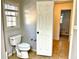 This is a bathroom featuring a window, toilet and open door at 460 Rabbit Run, Mcdonough, GA 30252