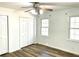 Bright bedroom with wood-look floors, ceiling fan, and double windows at 460 Rabbit Run, Mcdonough, GA 30252