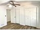 A bedroom featuring wood floors, a ceiling fan and multiple closets at 460 Rabbit Run, Mcdonough, GA 30252