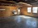 Inside the garage, with a sink, two windows, plywood walls, and a concrete floor at 460 Rabbit Run, Mcdonough, GA 30252